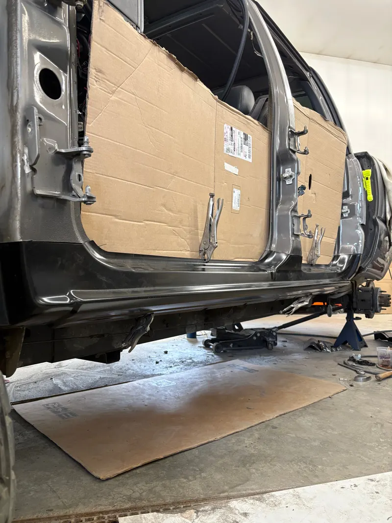 Lower body and rocker panel repair on a vehicle on stands